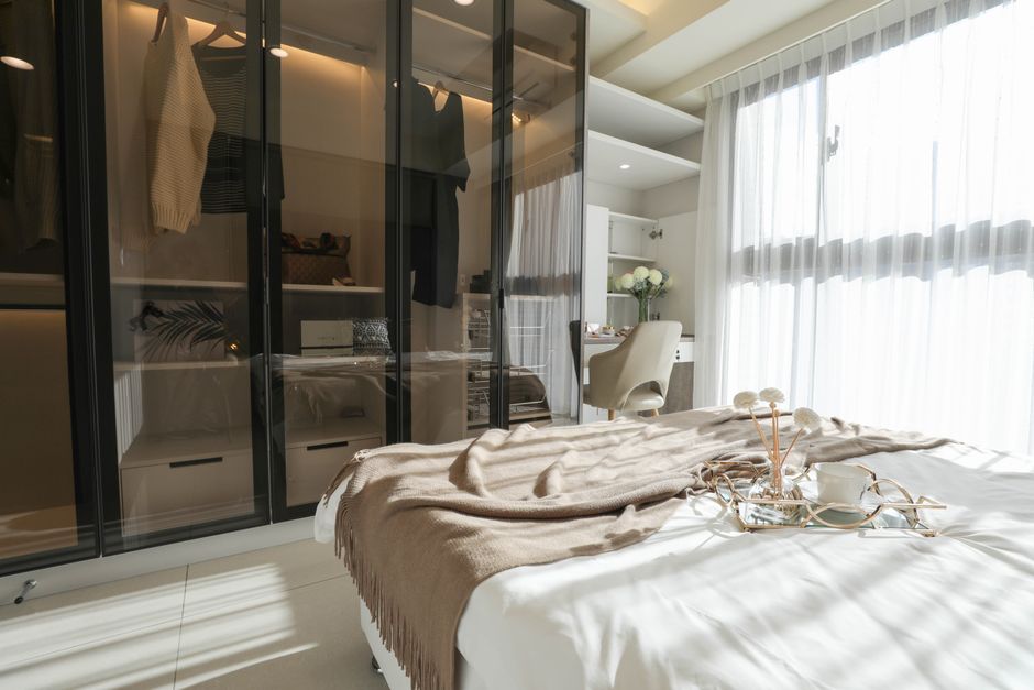 Bedroom with custom built-in wardrobe and modern lighting